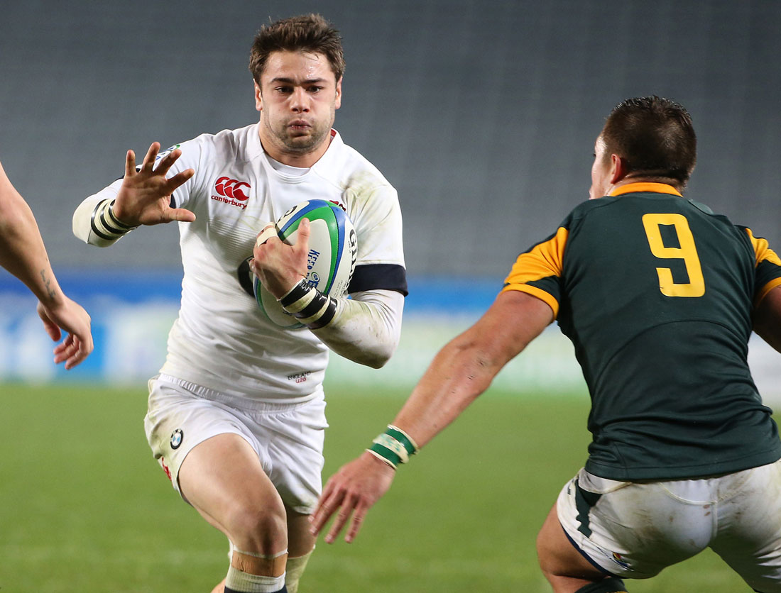 Henry Taylor of England (L) tries to evade a tackle by of JP Smith (R) of South Africa during the U20 Junior World Championship rugby union final 